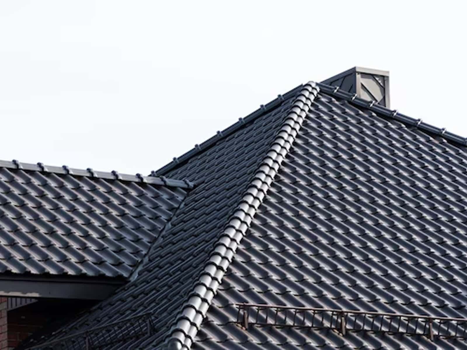 A damaged roof showing broken, missing, or worn-out shingles, tiles, or panels. The image highlights areas in need of repair or replacement, emphasizing roof wear, structural vulnerability, and the need for maintenance.