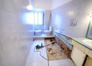 A bathroom featuring a toilet, a sink with a countertop, and a shower area. The space is clean and organized, with modern fixtures and a neutral color scheme. The layout maximizes functionality, making the room suitable for everyday use.