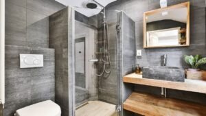 A bathroom featuring a shower, a sink with a countertop, and a toilet. The space is clean and organized, with modern fixtures and a neutral color scheme. The layout maximizes functionality, creating a practical and comfortable environment for daily use.