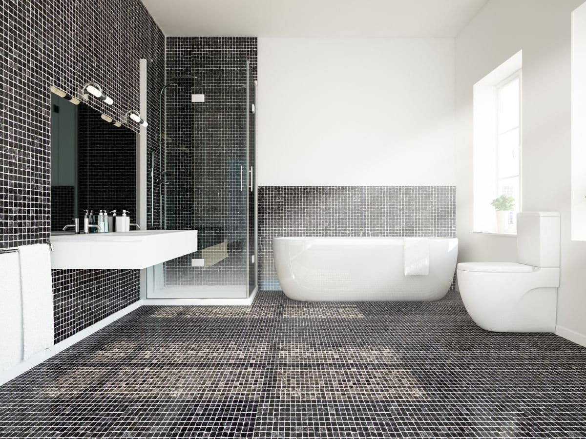 A modern bathroom with black and white tiles.