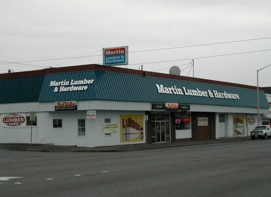 “Professional roofing crew working on a commercial building roof. The team is installing or repairing roofing materials such as metal panels, membrane roofing, or shingles, with safety equipment, tools, and scaffolding visible.”