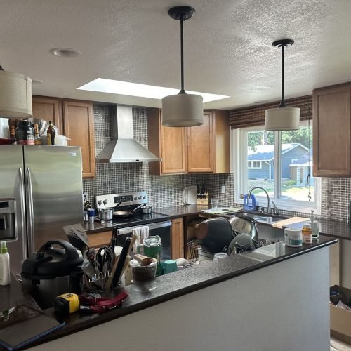 A functional kitchen featuring a sink, refrigerator, stove, and cabinets. The space is organized and well-lit, with countertops providing workspace and cabinetry offering storage. The combination of appliances and storage creates a practical and inviting cooking environment.